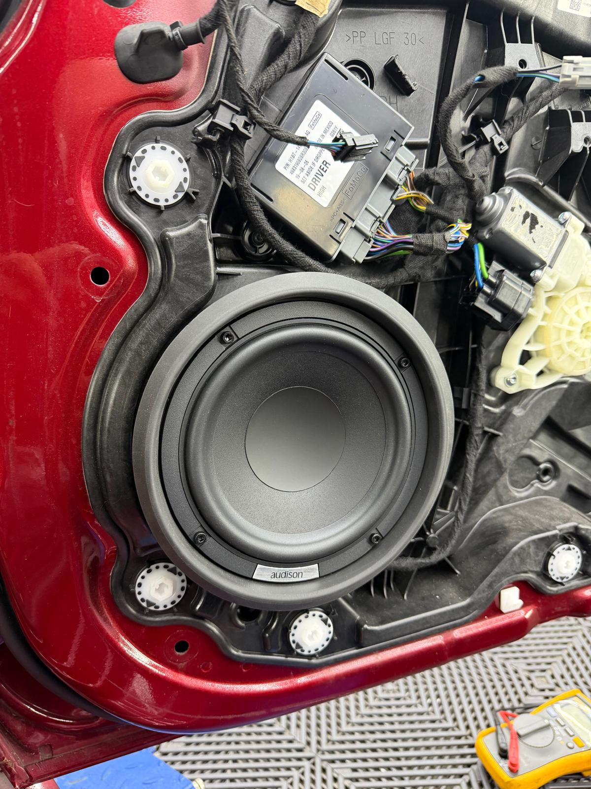Audison speaker fitted into a car door mid-install