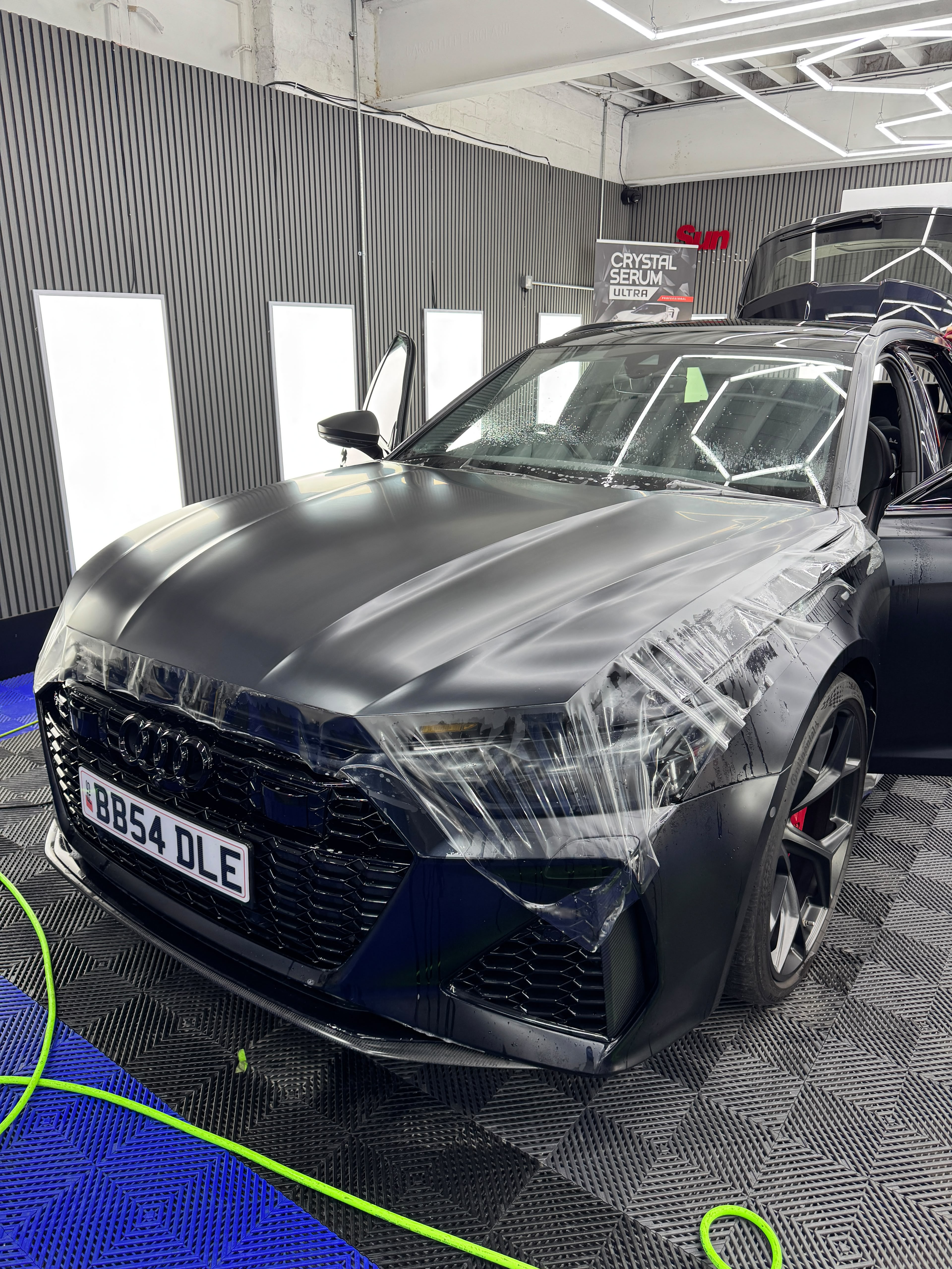 Audi RS6 mid-way through paint protection film installation