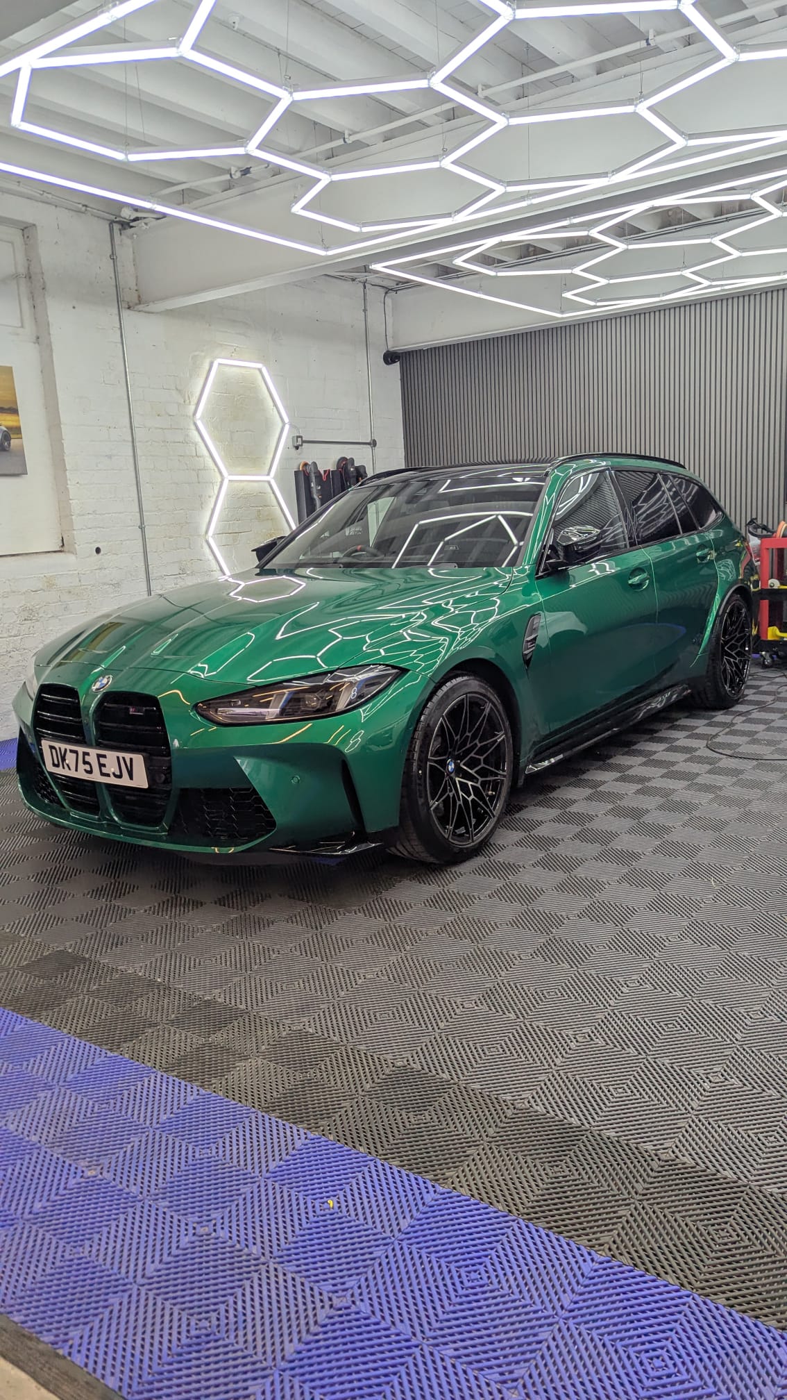 BMW M3 Touring with corrected paint under studio lighting