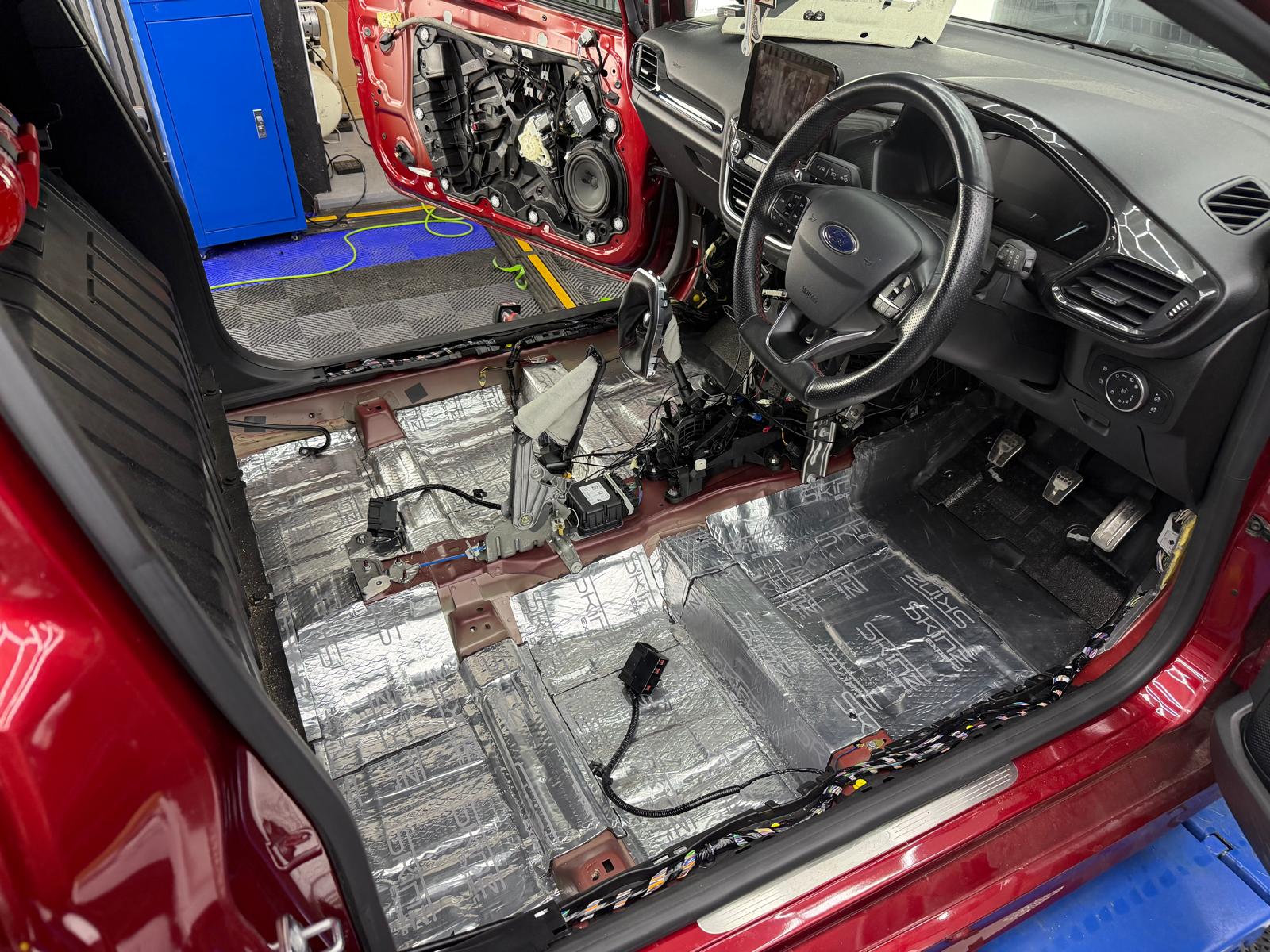 Sound deadening applied across the floor and sills of a stripped-out Ford Fiesta
