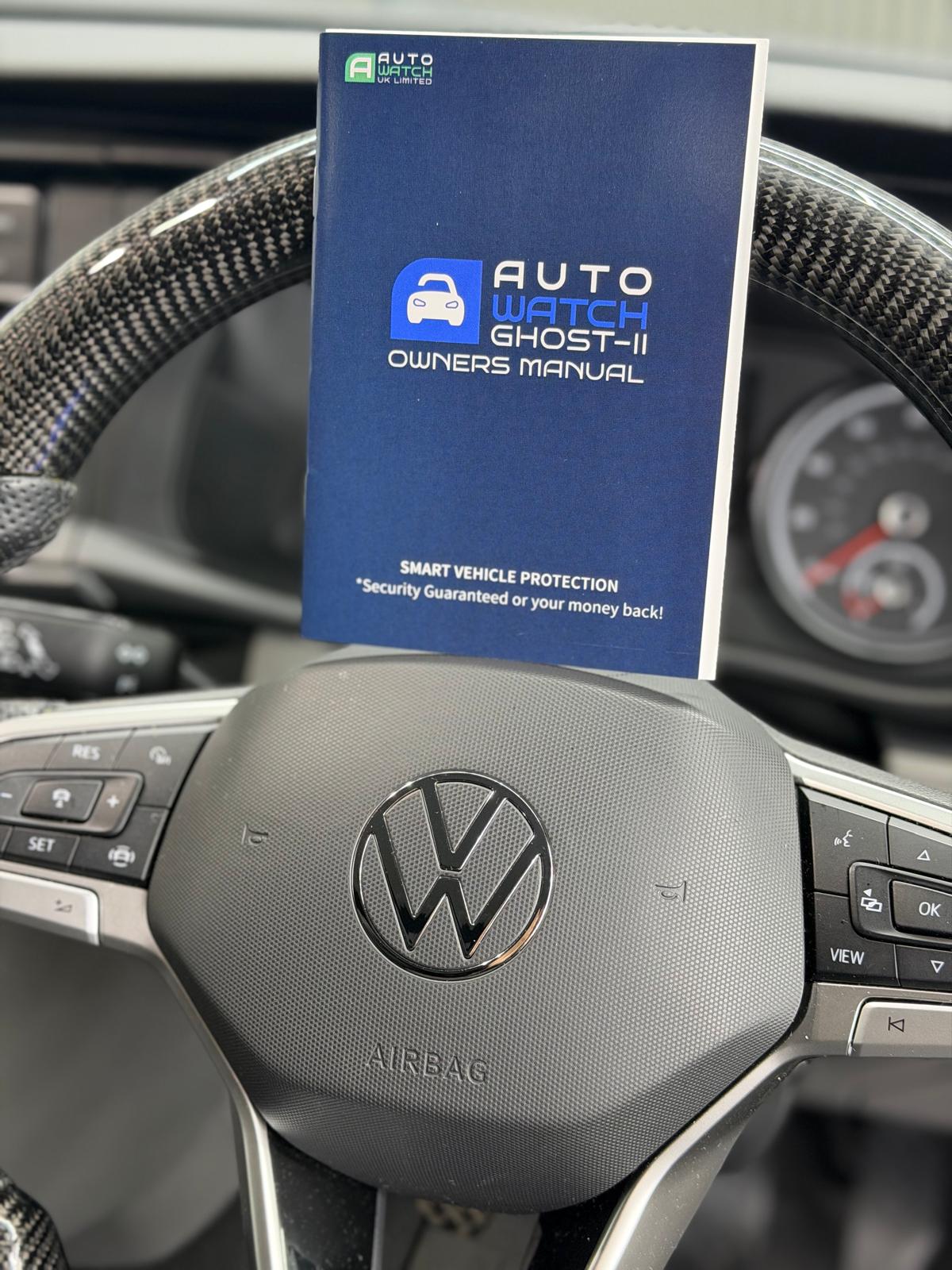 Autowatch Ghost II owner's manual on the steering wheel of a Volkswagen after fitting